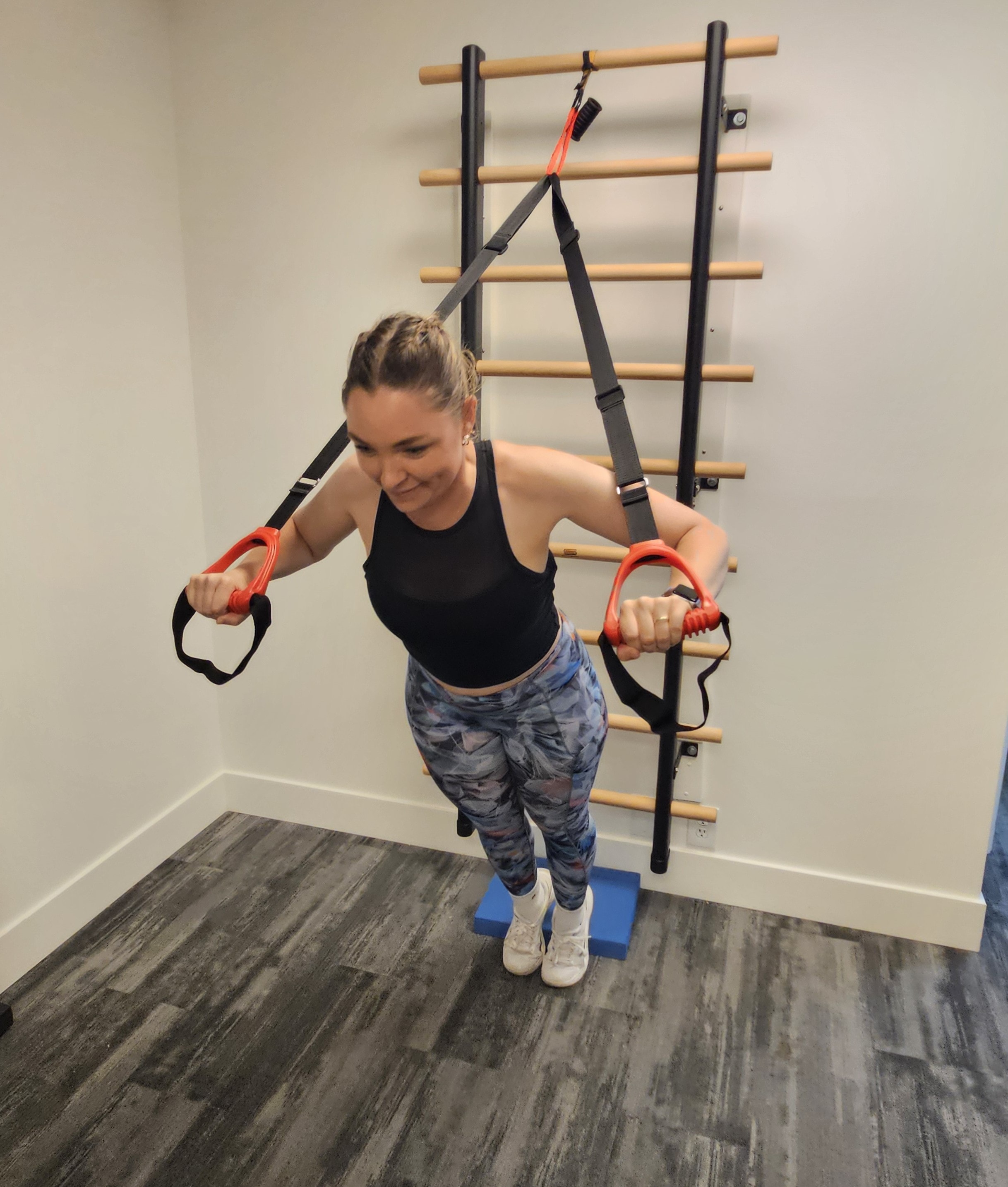 Client performing a suspension press exercise