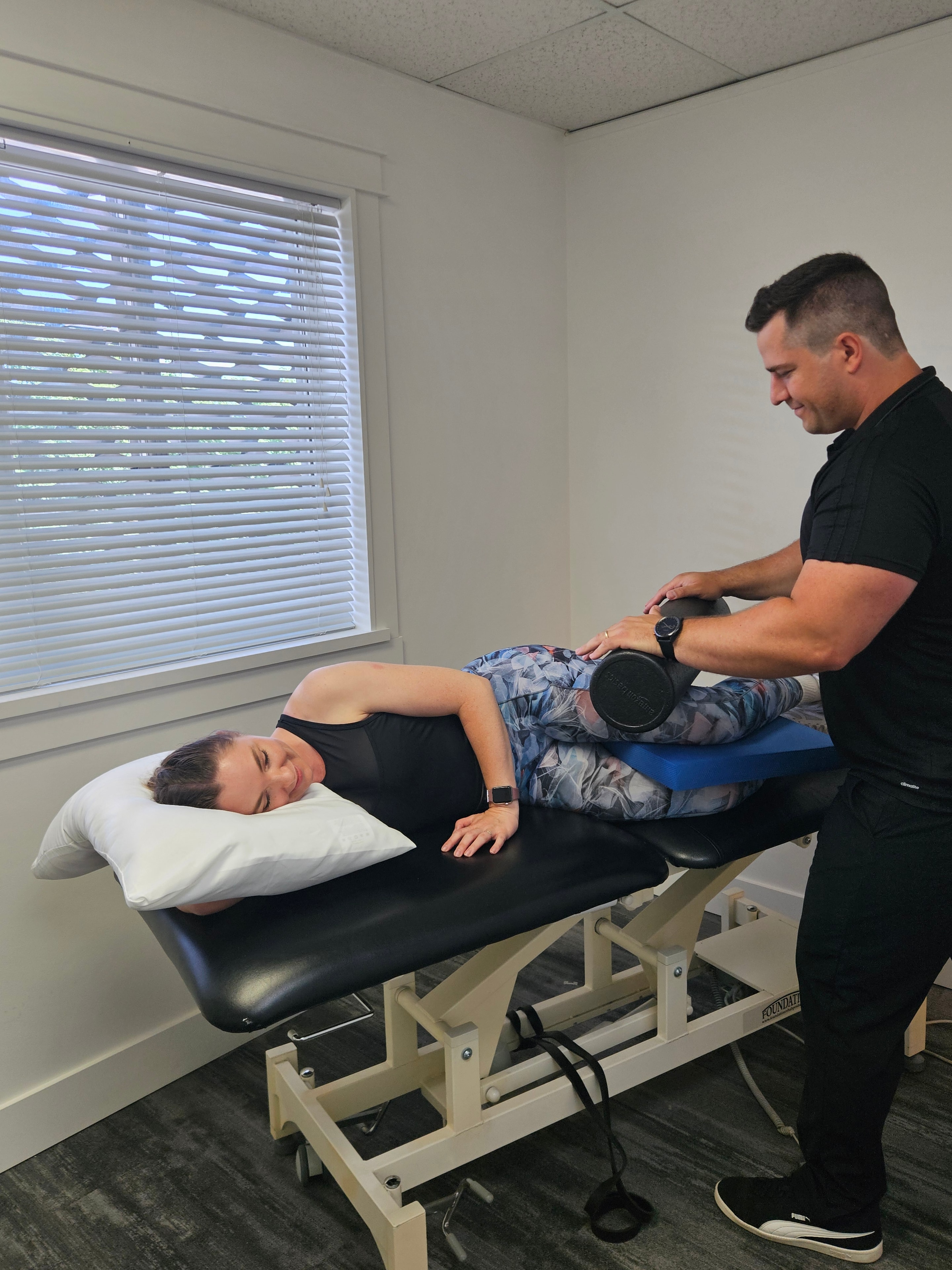 Kinesiologist providing hands-on support during a treatment session